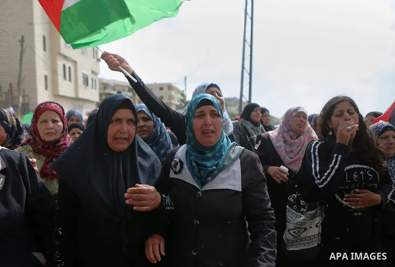 Relatives of Palestinian woman Maram Abu Ismail and her brother Ibrahim Taha, who were shot dead by Israeli police last month, mourn during their funeral near the West Bank city of Ramallah May 23, 2016. Photo by Shadi H...