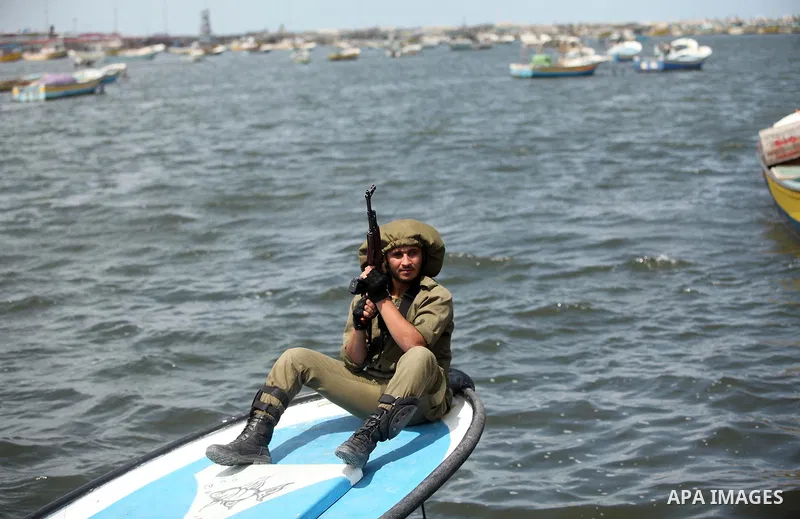 Palestinians take part in a protest against the Israeli blockade of the Gaza Strip at the Gaza seaport, on May 24, 2016. Photo by Ashraf Amra