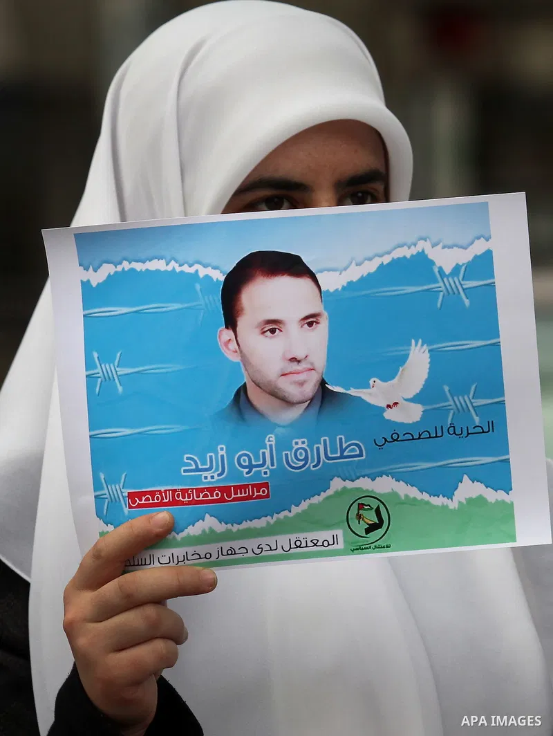 Palestinian journalists take part in a protest demanding the released for their colleague, Tareq Abu Zaid, the Journalist of Al-Aqsa TV, detained by Palestinian Authority, in the West bank city of Nablus, on May 24, 2016...