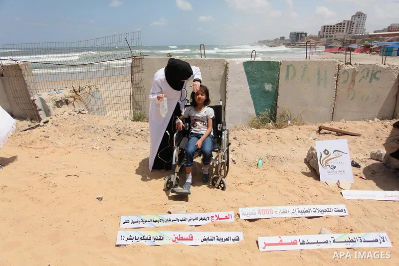 Palestinians take part in a protest against the Israeli blockade of the Gaza Strip at the Gaza seaport, on May 24, 2016. Photo by Ashraf Amra