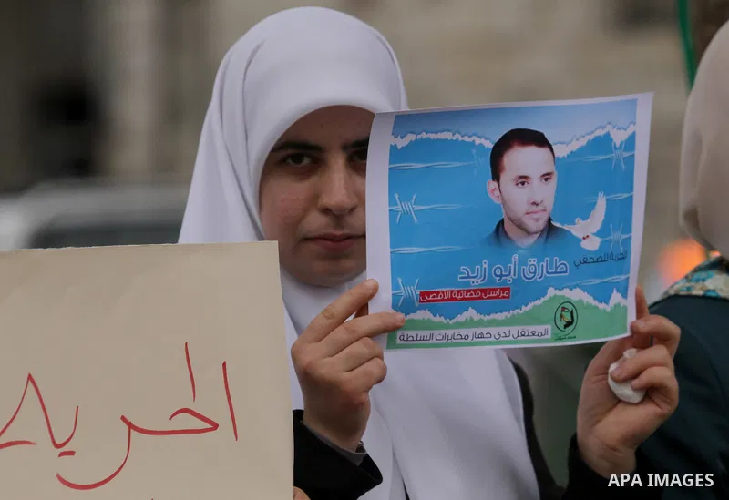 Palestinian journalists take part in a protest demanding the released for their colleague, Tareq Abu Zaid, the Journalist of Al-Aqsa TV, detained by Palestinian Authority, in the West bank city of Nablus, on May 24, 2016...