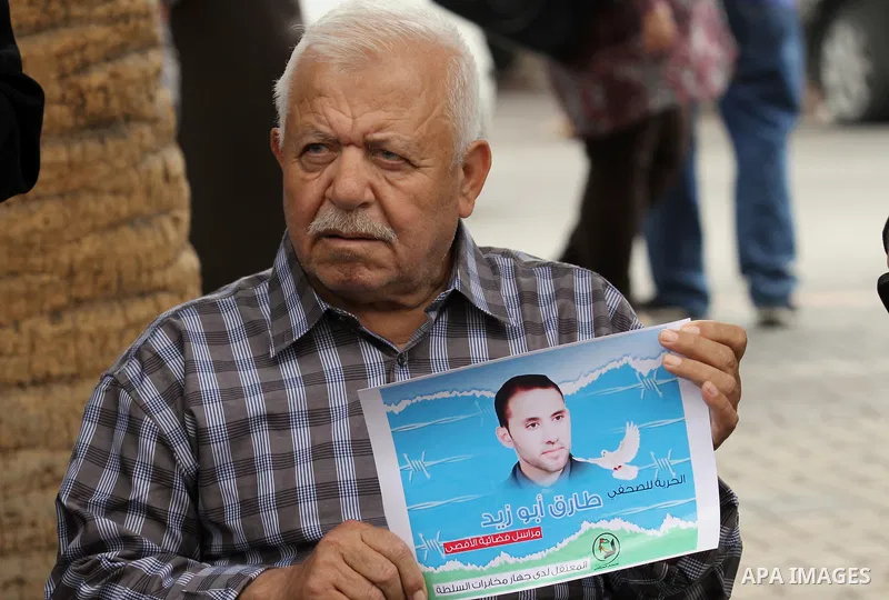 Palestinian journalists take part in a protest demanding the released for their colleague, Tareq Abu Zaid, the Journalist of Al-Aqsa TV, detained by Palestinian Authority, in the West bank city of Nablus, on May 24, 2016...