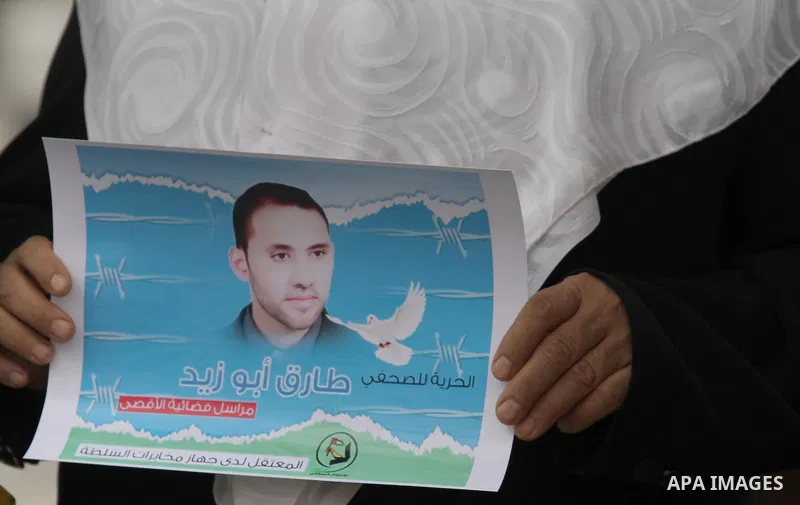 Palestinian journalists take part in a protest demanding the released for their colleague, Tareq Abu Zaid, the Journalist of Al-Aqsa TV, detained by Palestinian Authority, in the West bank city of Nablus, on May 24, 2016...