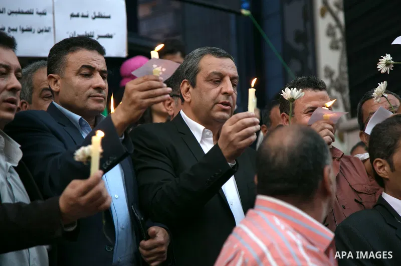 Egyptian journalists hold candles and placards supporting EgyptAir during a candlelight vigil for the victims of EgyptAir flight 804 in front of the Journalists' Syndicate in Cairo, Egypt, on May 24, 2016. The cause of T...