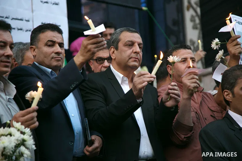 Egyptian journalists hold candles and placards supporting EgyptAir during a candlelight vigil for the victims of EgyptAir flight 804 in front of the Journalists' Syndicate in Cairo, Egypt, on May 24, 2016. The cause of T...