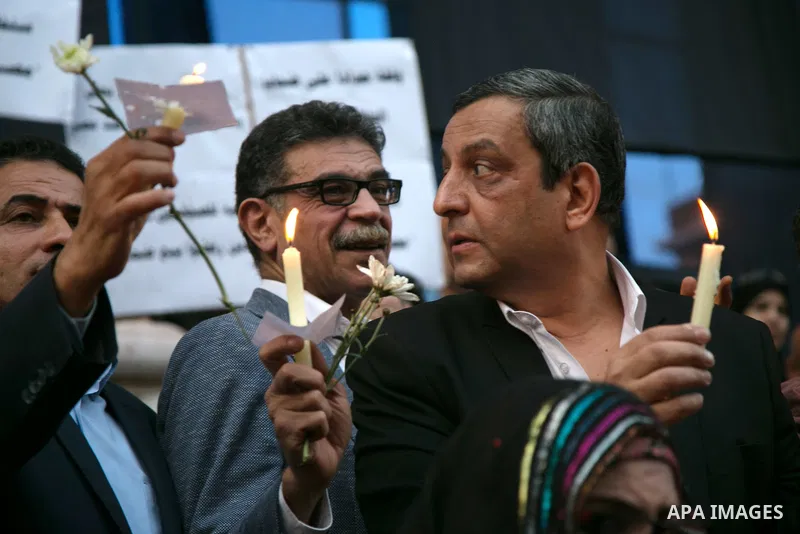 Egyptian journalists hold candles and placards supporting EgyptAir during a candlelight vigil for the victims of EgyptAir flight 804 in front of the Journalists' Syndicate in Cairo, Egypt, on May 24, 2016. The cause of T...