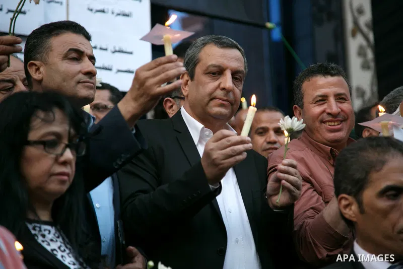 Egyptian journalists hold candles and placards supporting EgyptAir during a candlelight vigil for the victims of EgyptAir flight 804 in front of the Journalists' Syndicate in Cairo, Egypt, on May 24, 2016. The cause of T...