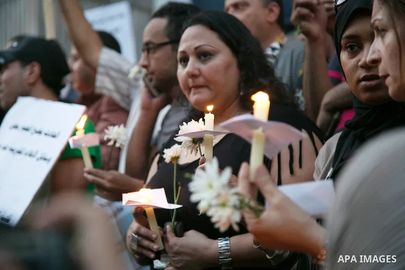 Egyptian journalists hold candles and placards supporting EgyptAir during a candlelight vigil for the victims of EgyptAir flight 804 in front of the Journalists' Syndicate in Cairo, Egypt, on May 24, 2016. The cause of T...
