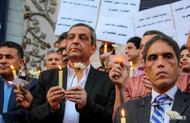 Egyptian journalists hold candles and placards supporting EgyptAir during a candlelight vigil for the victims of EgyptAir flight 804 in front of the Journalists' Syndicate in Cairo, Egypt, on May 24, 2016. The cause of T...