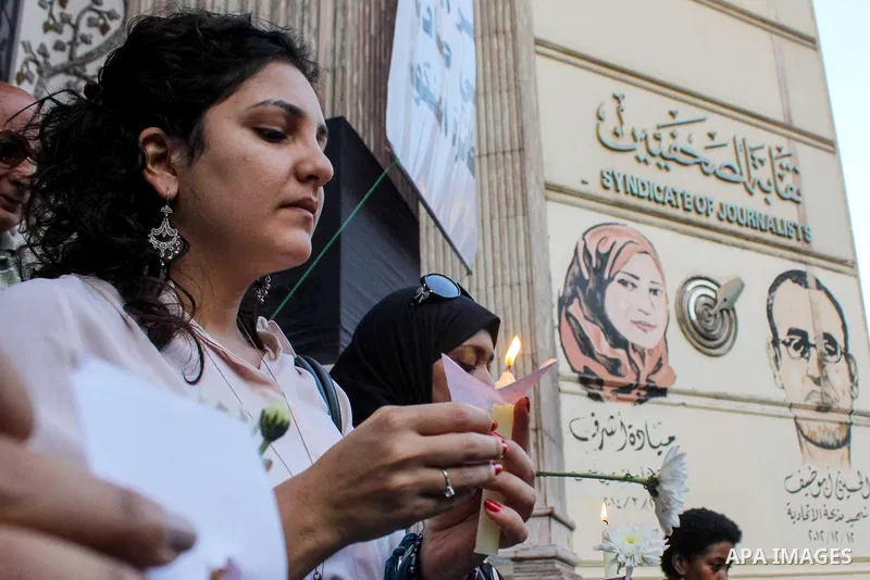 Egyptian journalists hold candles and placards supporting EgyptAir during a candlelight vigil for the victims of EgyptAir flight 804 in front of the Journalists' Syndicate in Cairo, Egypt, on May 24, 2016. The cause of T...