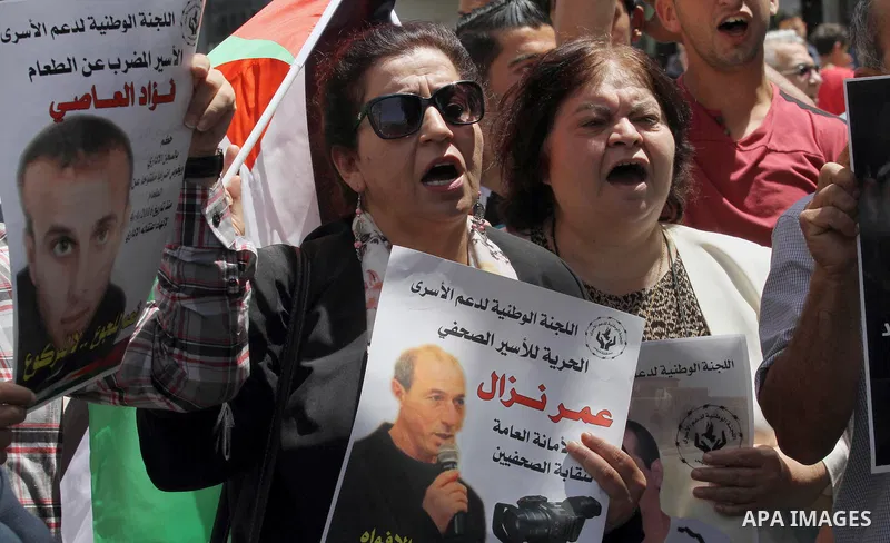 Palestinian relatives of patient prisoners in Israeli jails take part in a protest demanding for their release,in the West Bank city of Nablus on May 26, 2016. Photo by Nedal Eshtayah