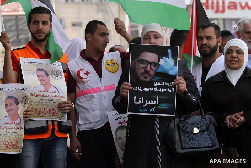 Palestinian relatives of patient prisoners in Israeli jails take part in a protest demanding for their release,in the West Bank city of Nablus on May 26, 2016. Photo by Nedal Eshtayah