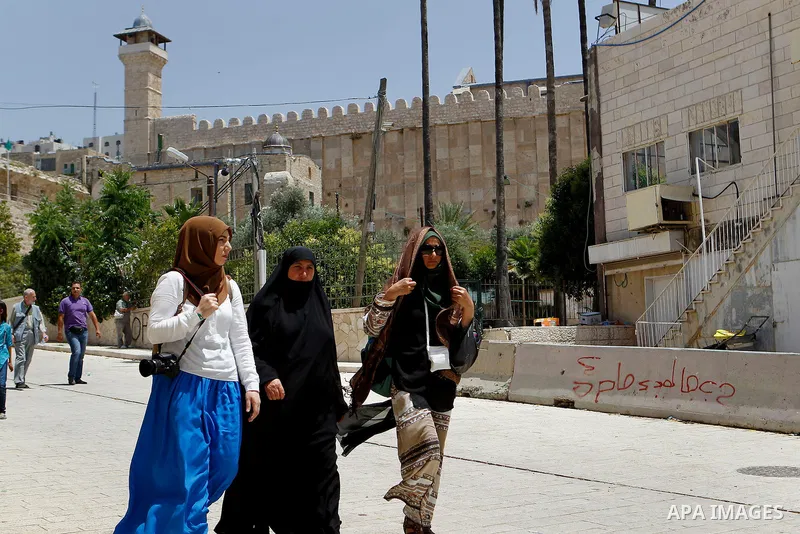 Turkish Muslim tourists make their way to the Ibrahimi mosque to pray in the Old Ciity of Hebron, 26 May 2016. The numbers of Turkish visitors increased compared to pervious years. Photo by Wisam Hashlamoun