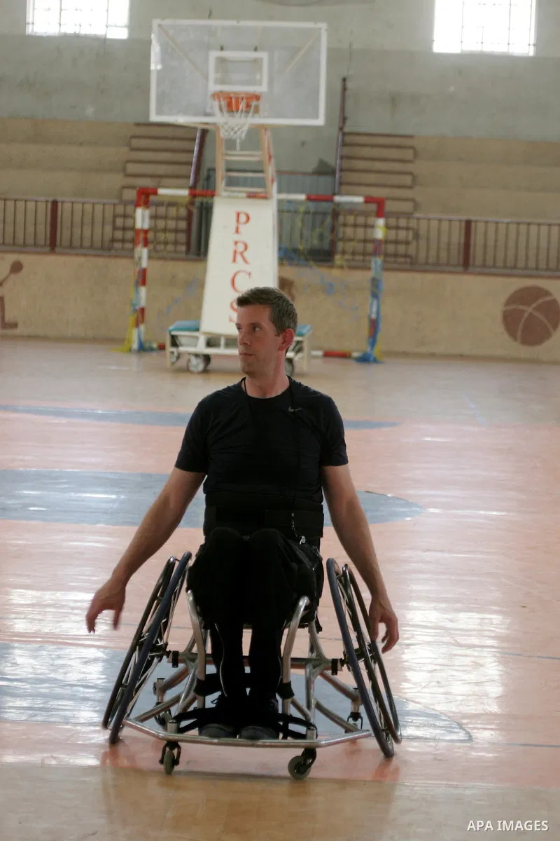 An American coach Jess marc, trains disabled Palestinians to play a basketball in Khan Younis in the southern Gaza strip, on May 26, 2016. Photo by Abed Rahim Khatib
