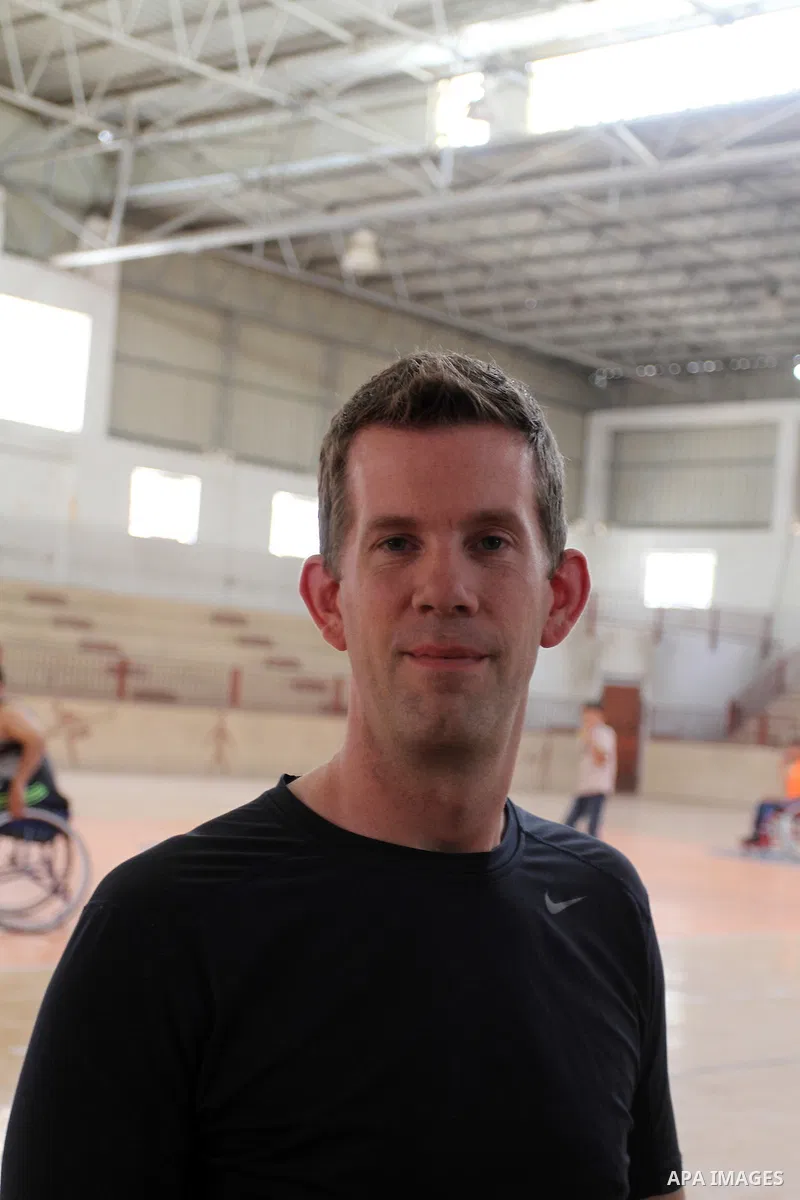 An American coach Jess marc, trains disabled Palestinians to play a basketball in Khan Younis in the southern Gaza strip, on May 26, 2016. Photo by Abed Rahim Khatib
