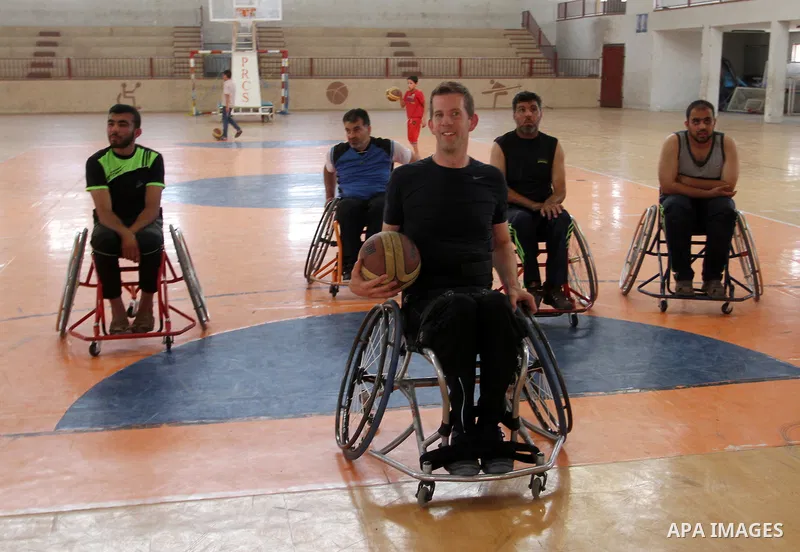 An American coach Jess marc, trains disabled Palestinians to play a basketball in Khan Younis in the southern Gaza strip, on May 26, 2016. Photo by Abed Rahim Khatib