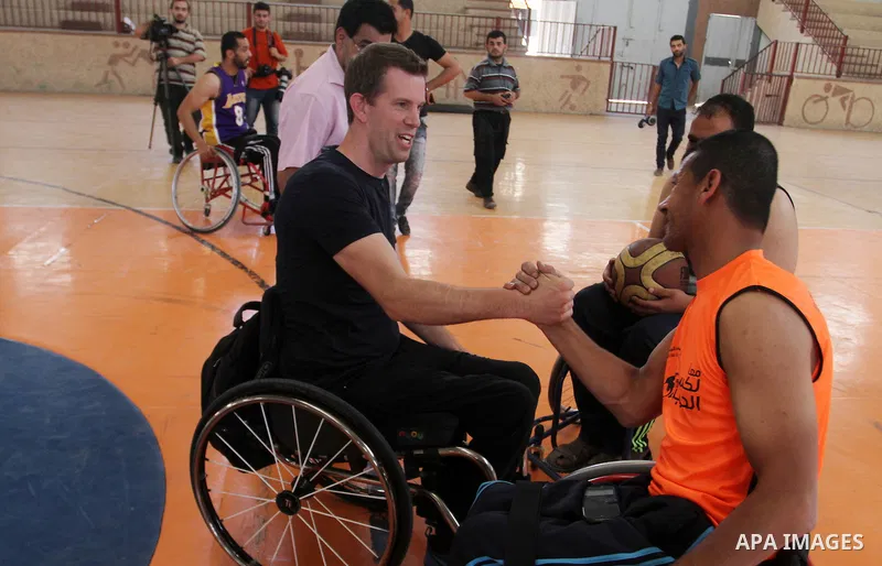An American coach Jess marc, trains disabled Palestinians to play a basketball in Khan Younis in the southern Gaza strip, on May 26, 2016. Photo by Abed Rahim Khatib