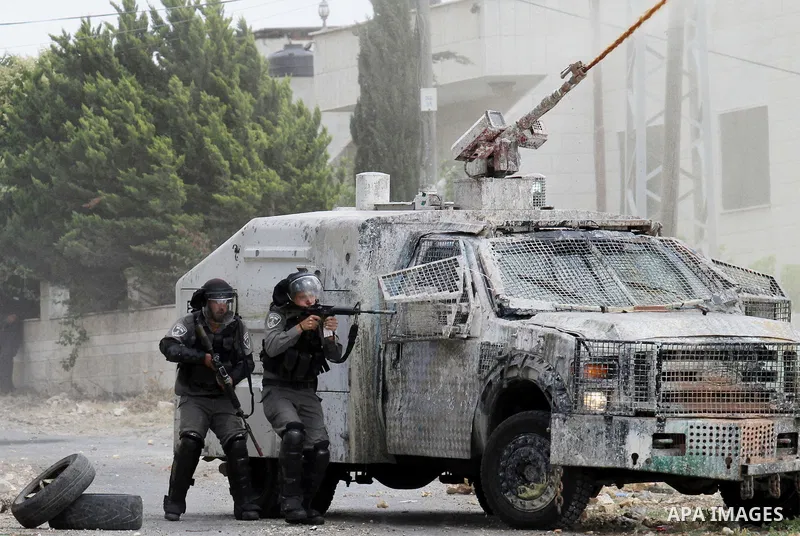 Israeli security forces aim at Palestinian protesters during clashes following a demonstration against the expropriation of Palestinian land by Israel, on May 27, 2016 in the village of Kfar Qaddum, near Nablus, in the o...