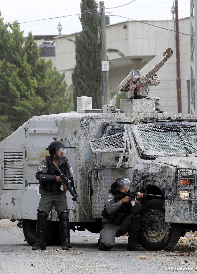 Israeli security forces aim at Palestinian protesters during clashes following a demonstration against the expropriation of Palestinian land by Israel, on May 27, 2016 in the village of Kfar Qaddum, near Nablus, in the o...