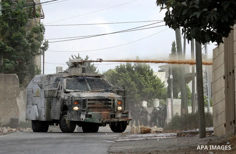 Israeli security forces spray foul-smelling water known as "skunk" towards Palestinian protesters during clashes following a demonstration against the expropriation of Palestinian land by Israel, on May 27, 2016 in the v...