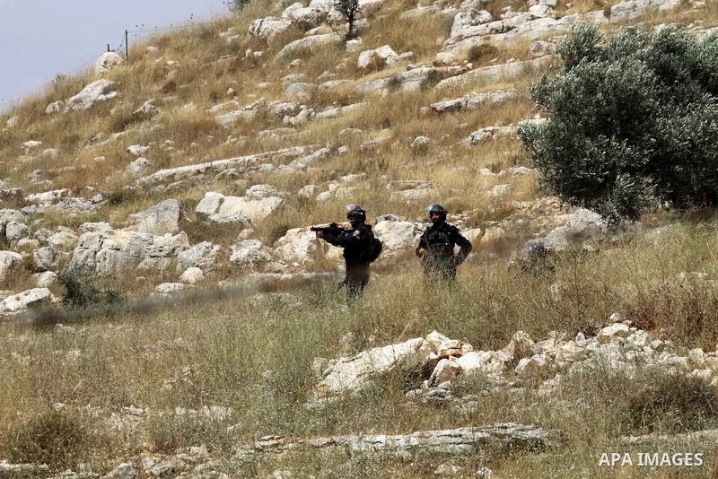 Israeli security forces aim at Palestinian protesters during clashes following a demonstration against the expropriation of Palestinian land by Israel, on May 27, 2016 in the village of Kfar Qaddum, near Nablus, in the o...