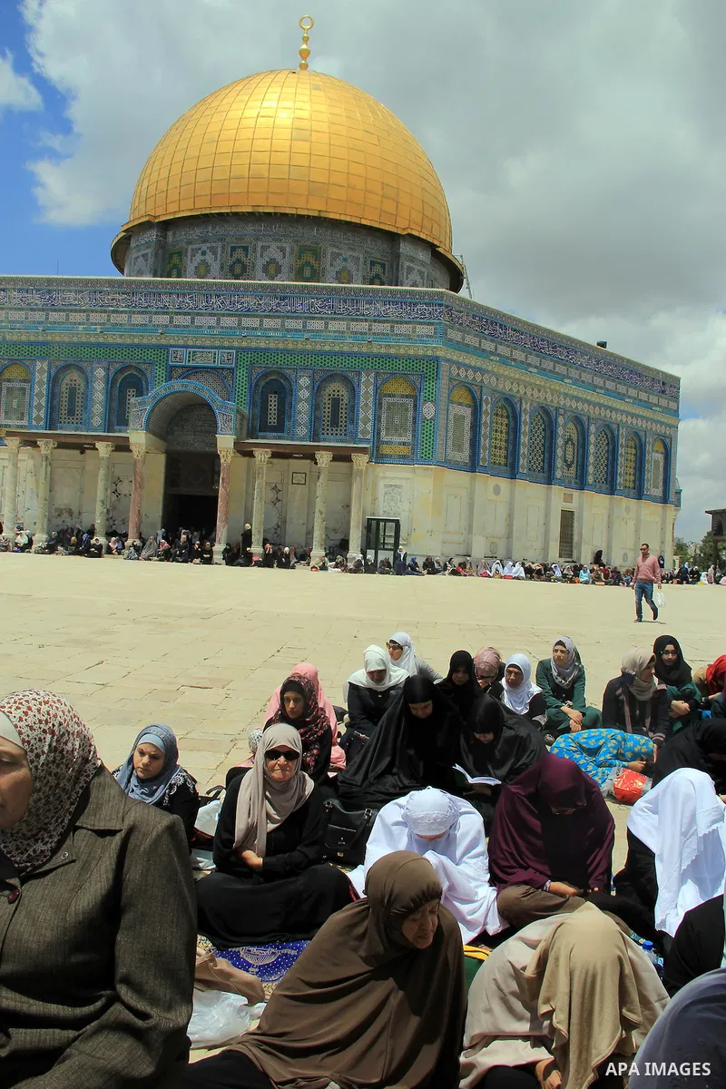 Palestinian Muslim worshipers attend Friday prayers outside al-Aqsa mosque, Islam's third holiest site, in Jerusalem's Old city on May, 27, 2016. Photo by Mahfouz Abu Turk