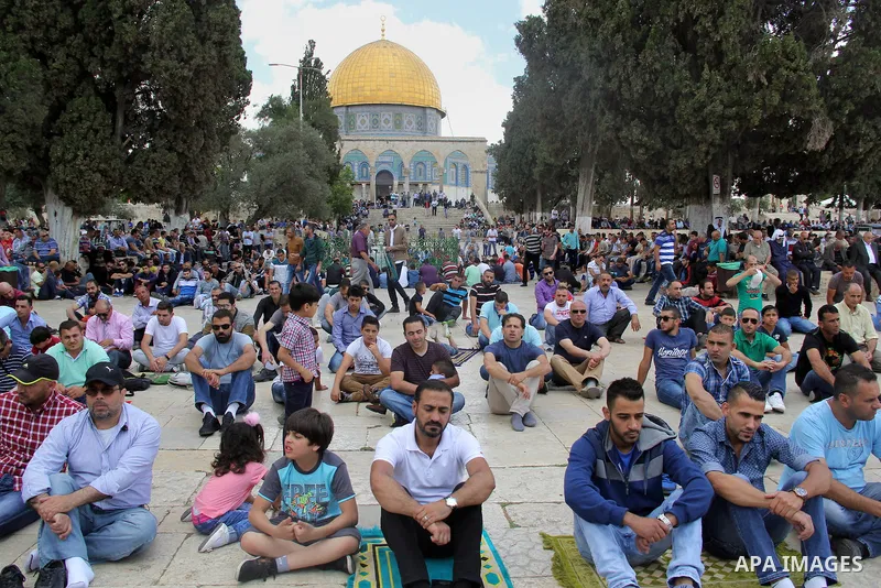 Palestinian Muslim worshipers attend Friday prayers outside al-Aqsa mosque, Islam's third holiest site, in Jerusalem's Old city on May, 27, 2016. Photo by Mahfouz Abu Turk