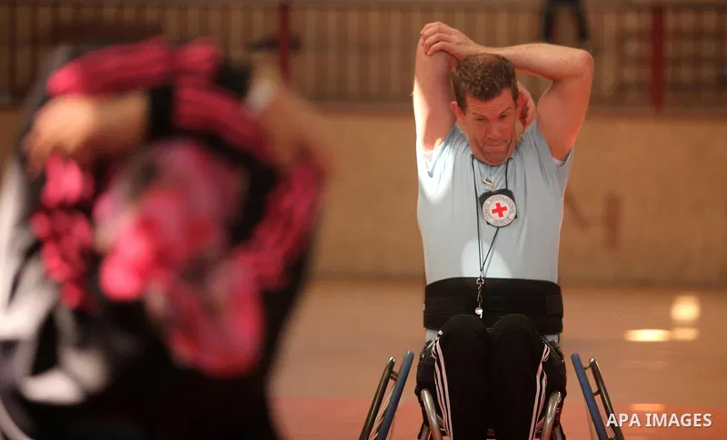 An American coach Jess marc, trains disabled Palestinians to play a basketball during a training course organised by the Palestinian Red Cross, in Khan Younis in the southern Gaza strip, on May 28, 2016. Photo by Ashraf...