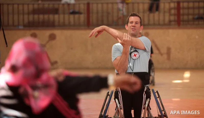An American coach Jess marc, trains disabled Palestinians to play a basketball during a training course organised by the Palestinian Red Cross, in Khan Younis in the southern Gaza strip, on May 28, 2016. Photo by Ashraf...