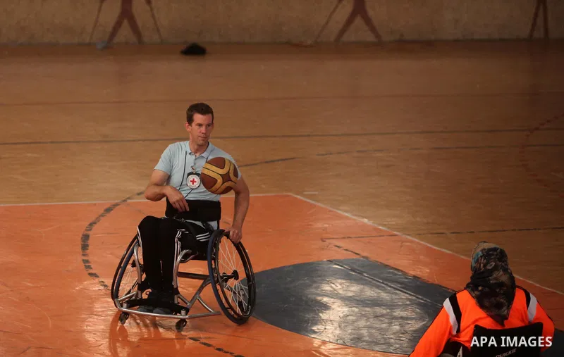 An American coach Jess marc, trains disabled Palestinians to play a basketball during a training course organised by the Palestinian Red Cross, in Khan Younis in the southern Gaza strip, on May 28, 2016. Photo by Ashraf...