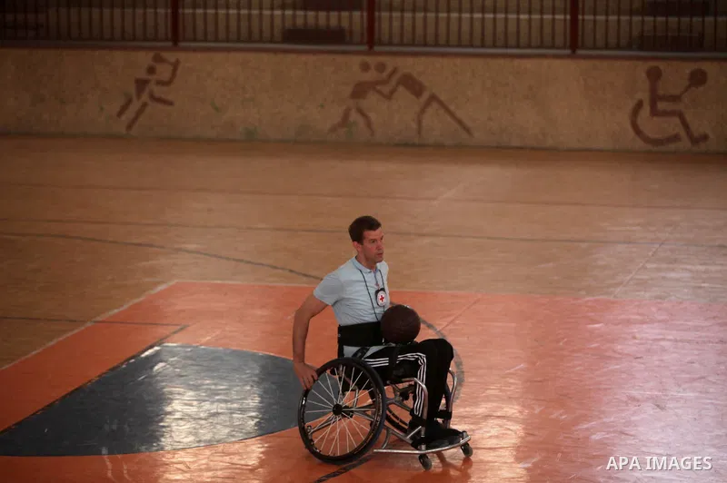 An American coach Jess marc, trains disabled Palestinians to play a basketball during a training course organised by the Palestinian Red Cross, in Khan Younis in the southern Gaza strip, on May 28, 2016. Photo by Ashraf...
