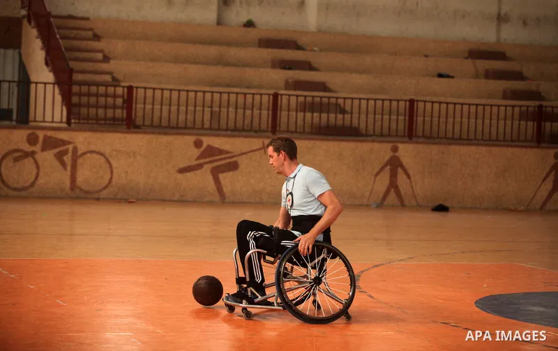An American coach Jess marc, trains disabled Palestinians to play a basketball during a training course organised by the Palestinian Red Cross, in Khan Younis in the southern Gaza strip, on May 28, 2016. Photo by Ashraf...