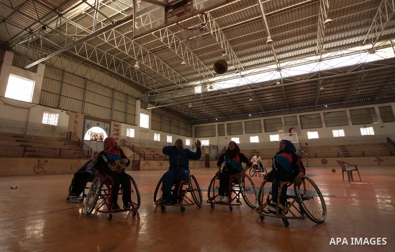 Disabled Palestinians take part in a training course to play basketball organised by the Palestinian Red Cross, in Khan Younis in the southern Gaza strip, on May 28, 2016. Photo by Ashraf Amra