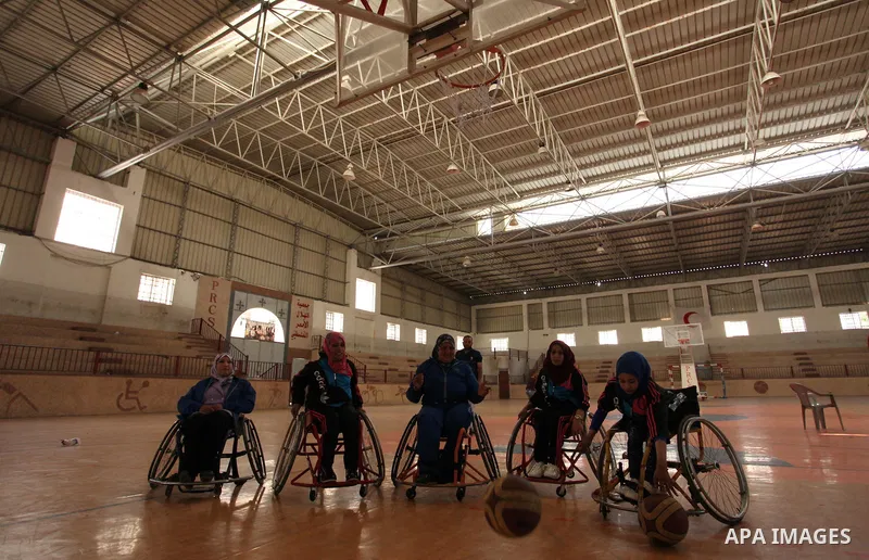 Disabled Palestinians take part in a training course to play basketball organised by the Palestinian Red Cross, in Khan Younis in the southern Gaza strip, on May 28, 2016. Photo by Ashraf Amra