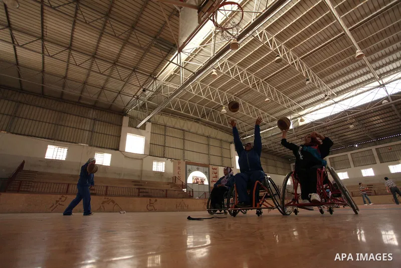 Disabled Palestinians take part in a training course to play basketball organised by the Palestinian Red Cross, in Khan Younis in the southern Gaza strip, on May 28, 2016. Photo by Ashraf Amra