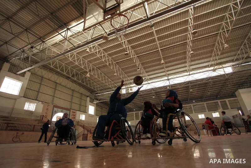 Disabled Palestinians take part in a training course to play basketball organised by the Palestinian Red Cross, in Khan Younis in the southern Gaza strip, on May 28, 2016. Photo by Ashraf Amra