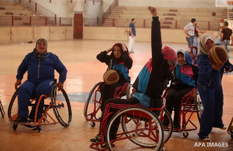 Disabled Palestinians take part in a training course to play basketball organised by the Palestinian Red Cross, in Khan Younis in the southern Gaza strip, on May 28, 2016. Photo by Ashraf Amra