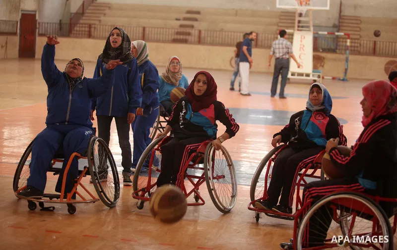 Disabled Palestinians take part in a training course to play basketball organised by the Palestinian Red Cross, in Khan Younis in the southern Gaza strip, on May 28, 2016. Photo by Ashraf Amra