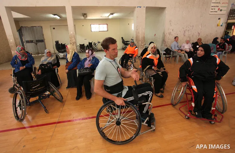 An American coach Jess marc, trains disabled Palestinians to play a basketball during a training course organised by the Palestinian Red Cross, in Khan Younis in the southern Gaza strip, on May 28, 2016. Photo by Ashraf...