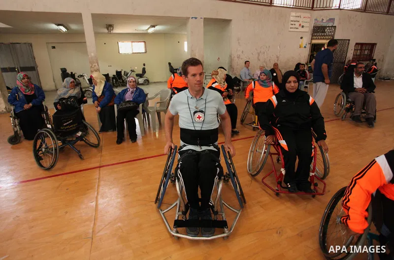 An American coach Jess marc, trains disabled Palestinians to play a basketball during a training course organised by the Palestinian Red Cross, in Khan Younis in the southern Gaza strip, on May 28, 2016. Photo by Ashraf...