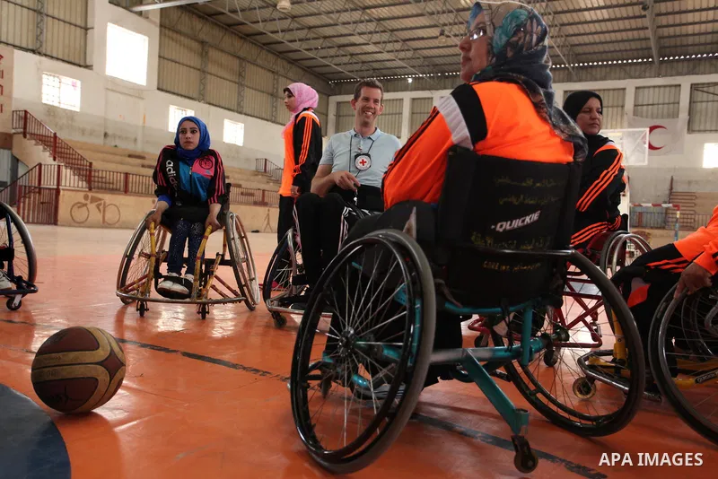 An American coach Jess marc, trains disabled Palestinians to play a basketball during a training course organised by the Palestinian Red Cross, in Khan Younis in the southern Gaza strip, on May 28, 2016. Photo by Ashraf...