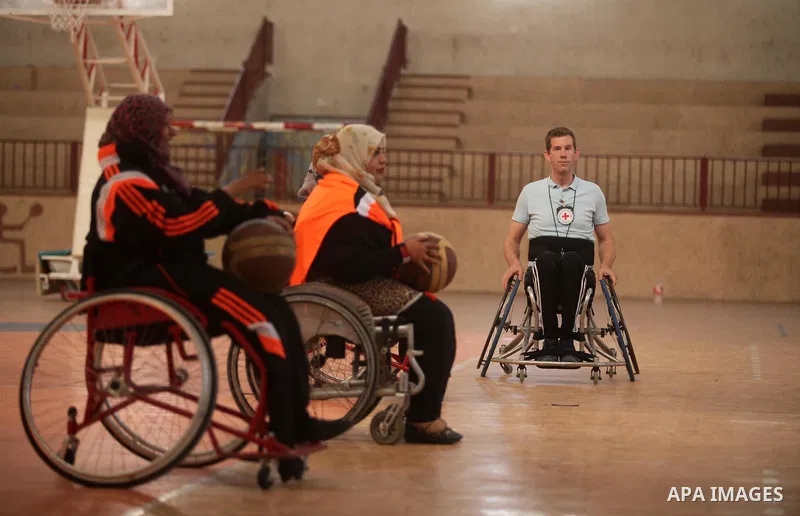 An American coach Jess marc, trains disabled Palestinians to play a basketball during a training course organised by the Palestinian Red Cross, in Khan Younis in the southern Gaza strip, on May 28, 2016. Photo by Ashraf...