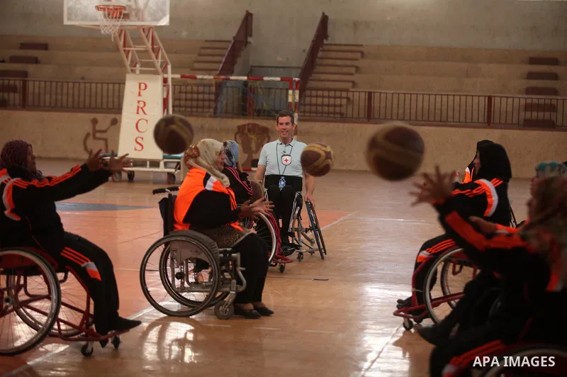 An American coach Jess marc, trains disabled Palestinians to play a basketball during a training course organised by the Palestinian Red Cross, in Khan Younis in the southern Gaza strip, on May 28, 2016. Photo by Ashraf...