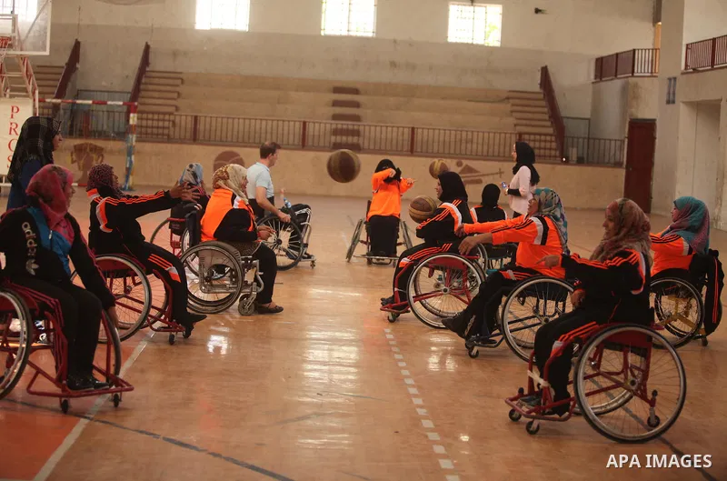 An American coach Jess marc, trains disabled Palestinians to play a basketball during a training course organised by the Palestinian Red Cross, in Khan Younis in the southern Gaza strip, on May 28, 2016. Photo by Ashraf...
