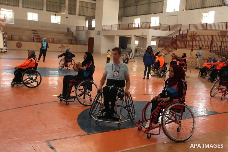An American coach Jess marc, trains disabled Palestinians to play a basketball during a training course organised by the Palestinian Red Cross, in Khan Younis in the southern Gaza strip, on May 28, 2016. Photo by Ashraf...