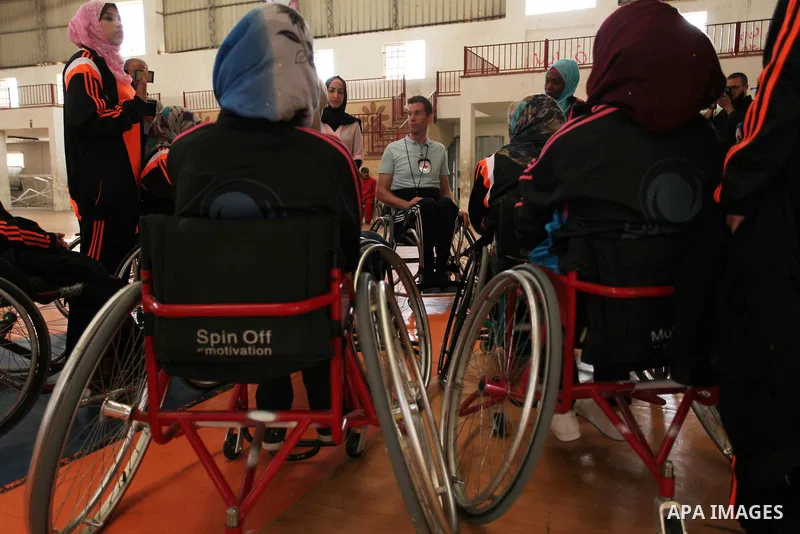 An American coach Jess marc, trains disabled Palestinians to play a basketball during a training course organised by the Palestinian Red Cross, in Khan Younis in the southern Gaza strip, on May 28, 2016. Photo by Ashraf...