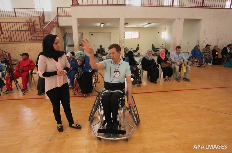 An American coach Jess marc, trains disabled Palestinians to play a basketball during a training course organised by the Palestinian Red Cross, in Khan Younis in the southern Gaza strip, on May 28, 2016. Photo by Ashraf...