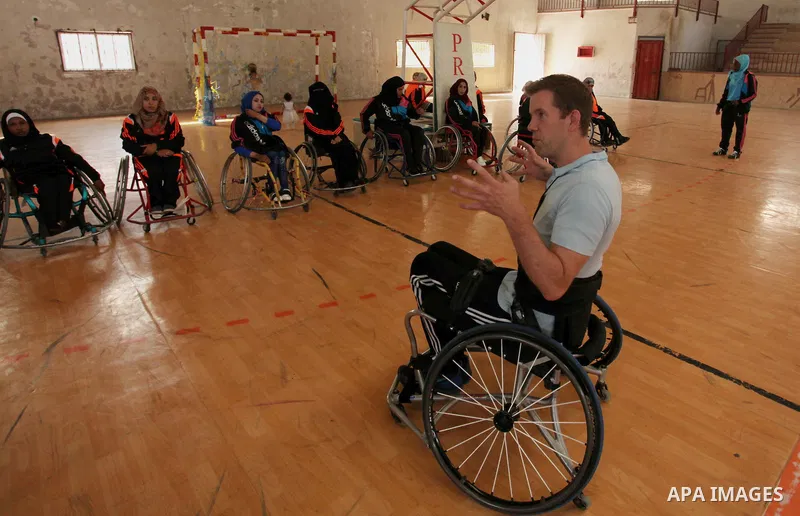 An American coach Jess marc, trains disabled Palestinians to play a basketball during a training course organised by the Palestinian Red Cross, in Khan Younis in the southern Gaza strip, on May 28, 2016. Photo by Ashraf...