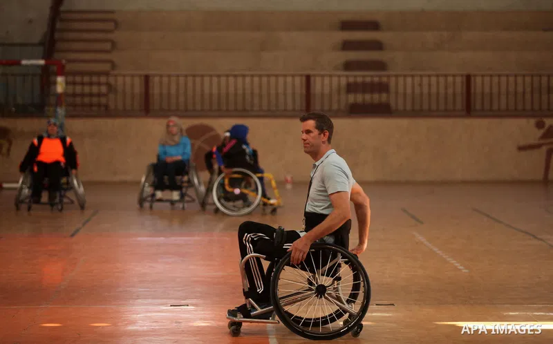 An American coach Jess marc, trains disabled Palestinians to play a basketball during a training course organised by the Palestinian Red Cross, in Khan Younis in the southern Gaza strip, on May 28, 2016. Photo by Ashraf...