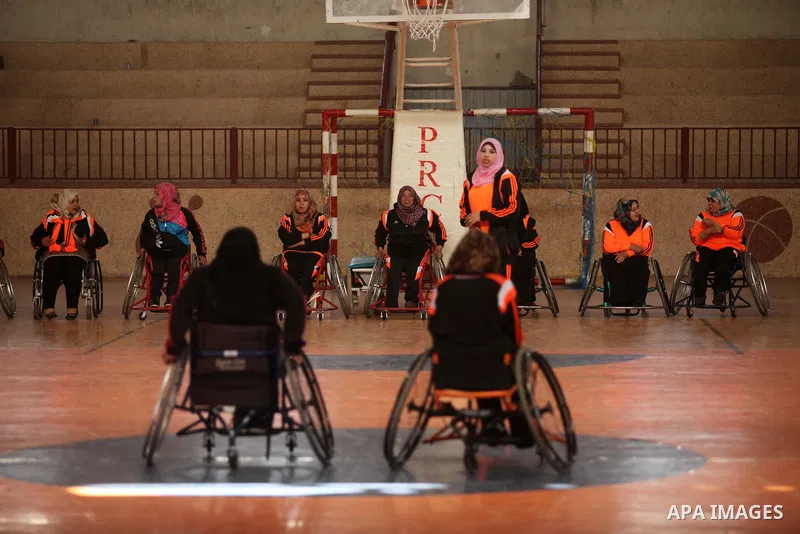 Disabled Palestinians take part in a training course to play basketball organised by the Palestinian Red Cross, in Khan Younis in the southern Gaza strip, on May 28, 2016. Photo by Ashraf Amra